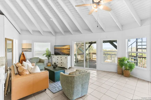 a living room with furniture and a floor to ceiling window