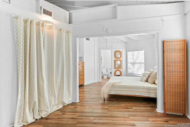 a bedroom with a bed and a window