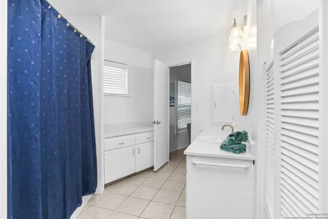 a bathroom with a bathtub sink and mirror