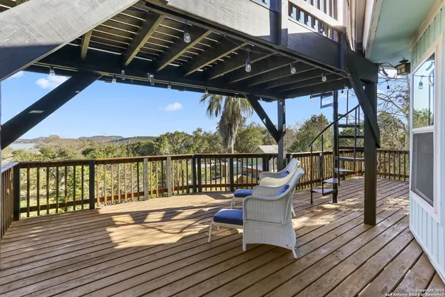 a view of balcony with wooden floor and outdoor seating