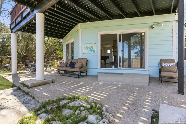 a view of a porch with furniture and floor to ceiling window