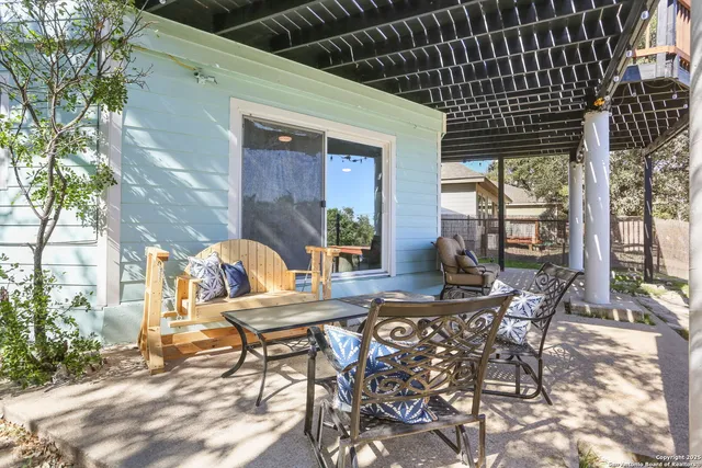 a view of a patio with table and chairs and potted plants