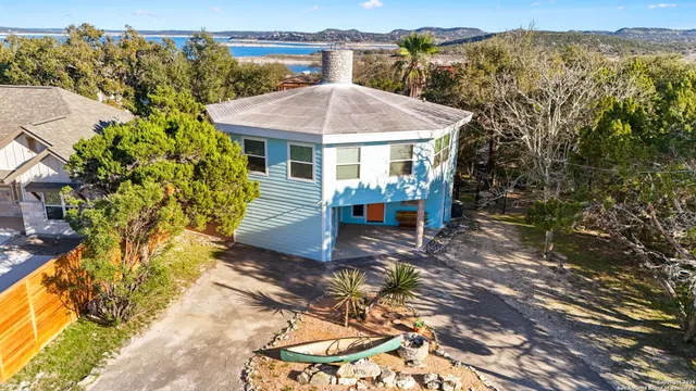 a view of a patio with a table and chairs under an umbrella