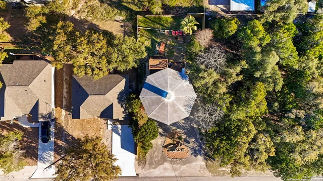 an aerial view of residential house with outdoor space and trees