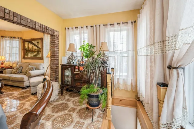 a living room with furniture and a potted plant