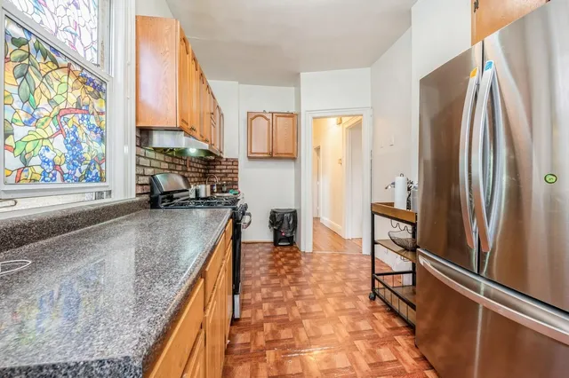 a kitchen with stainless steel appliances granite countertop a refrigerator and a sink