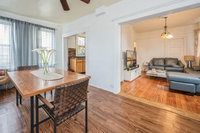 a living room with dining table furniture and a wooden floor