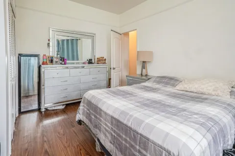 a bedroom with a bed and a mirror