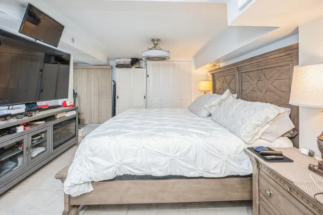 a bedroom with a bed and a flat tv screen