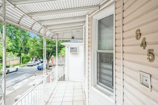 a view of a balcony with couch and wooden floor