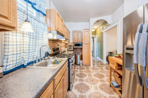 a kitchen with stainless steel appliances granite countertop a sink and a counter space