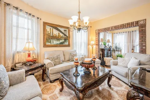 a living room with furniture and a chandelier