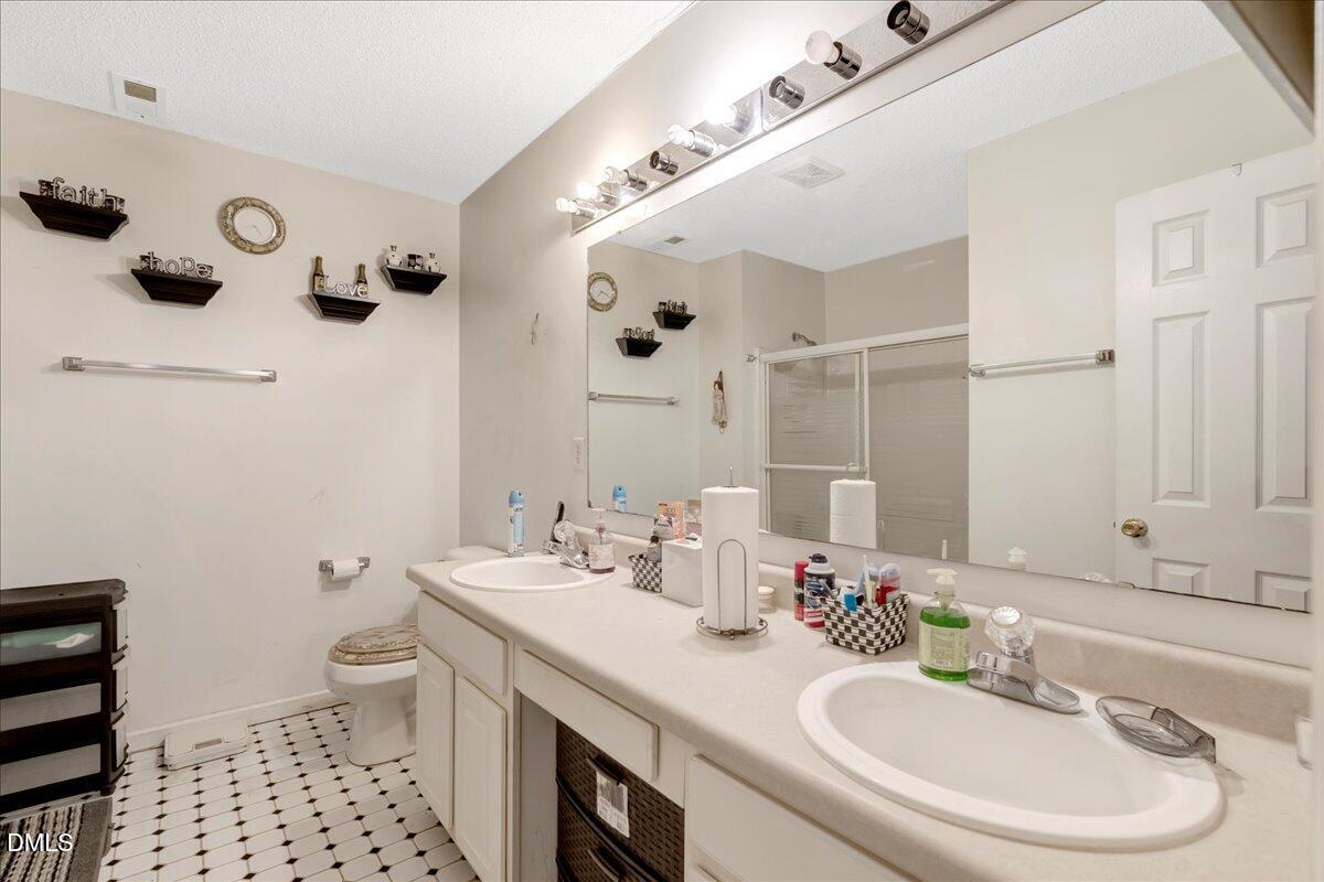 656 No Bottom Road Warrenton, NC 27589 - Photo 10 of 26 a bathroom with a sink a toilet a shower and a mirror