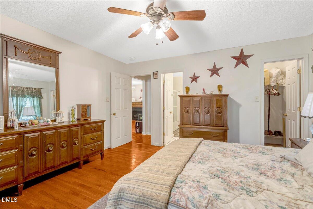 656 No Bottom Road Warrenton, NC 27589 - Photo 11 of 26 a bedroom with a large bed and a chandelier