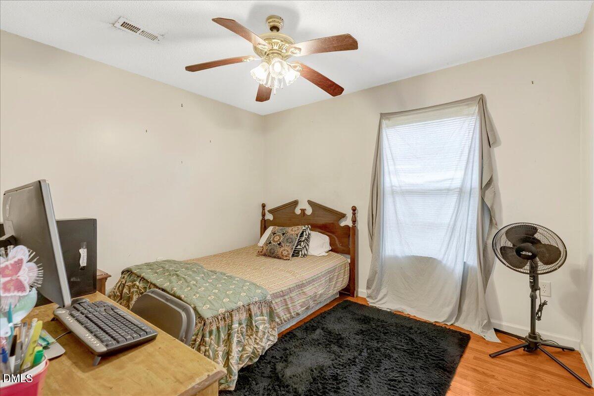 656 No Bottom Road Warrenton, NC 27589 - Photo 14 of 26 a bedroom with a bed and wooden floor