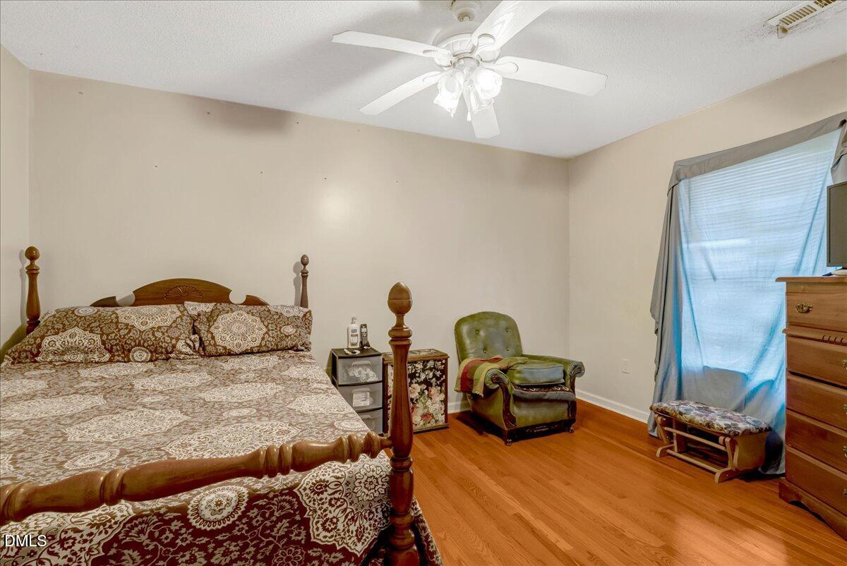 656 No Bottom Road Warrenton, NC 27589 - Photo 16 of 26 a bedroom with a bed and wooden floor