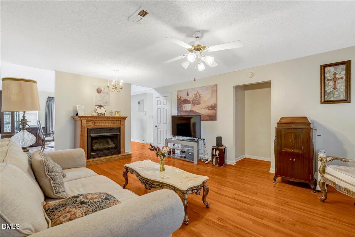 656 No Bottom Road Warrenton, NC 27589 - Photo 7 of 26 a living room with furniture a fireplace and a flat screen tv