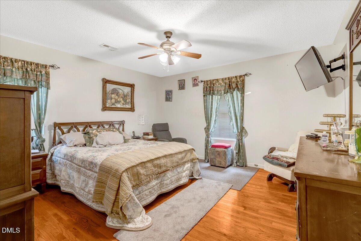 656 No Bottom Road Warrenton, NC 27589 - Photo 9 of 26 a bedroom with a bed and a chandelier