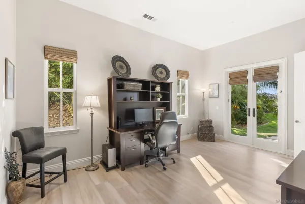 a bedroom with furniture and a wooden floor