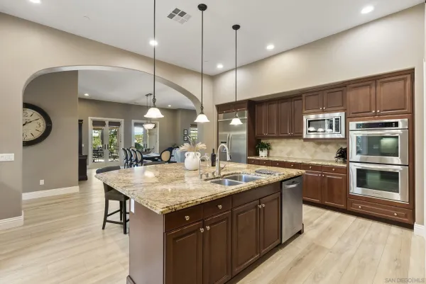 a spacious bathroom with a double vanity sink a mirror and a bathtub
