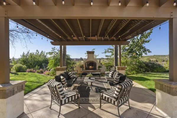 a view of a patio with a table chairs and a yard