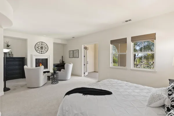 a view of a house with a big yard potted plants and a large tree