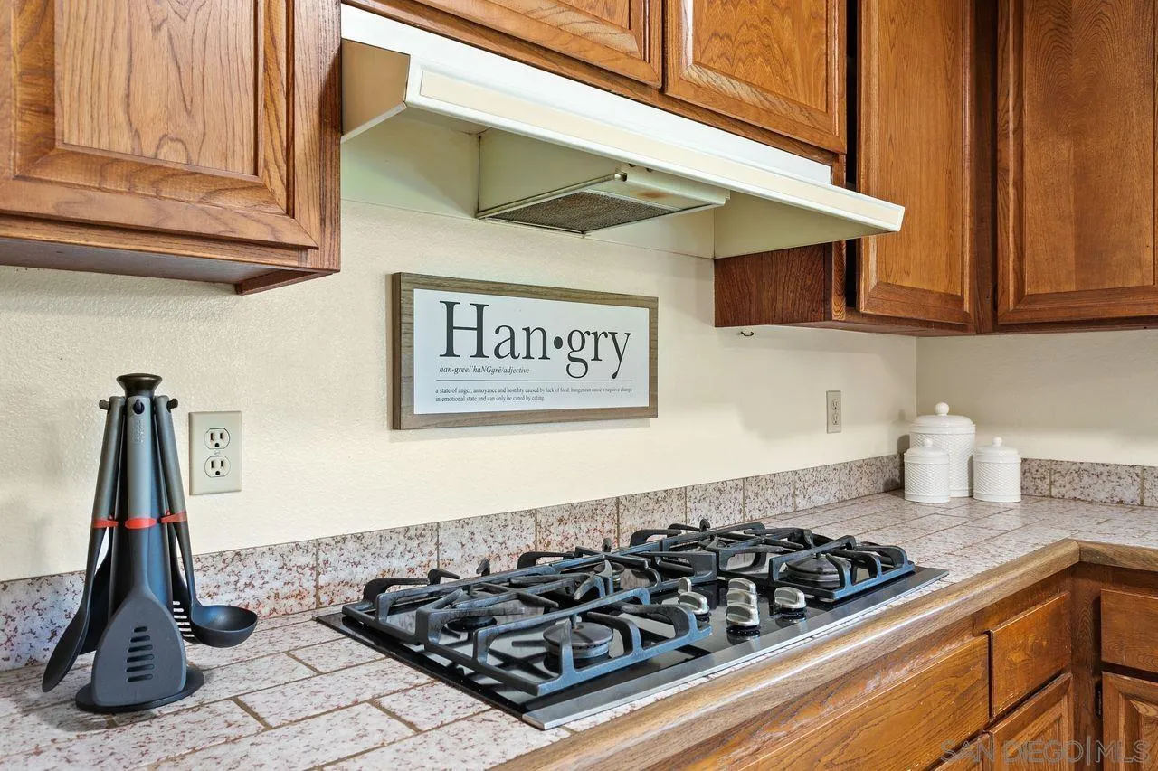 12805 Pinefield Road Poway, CA 92064 - Photo 11 of 31 a kitchen with a stove and cabinets