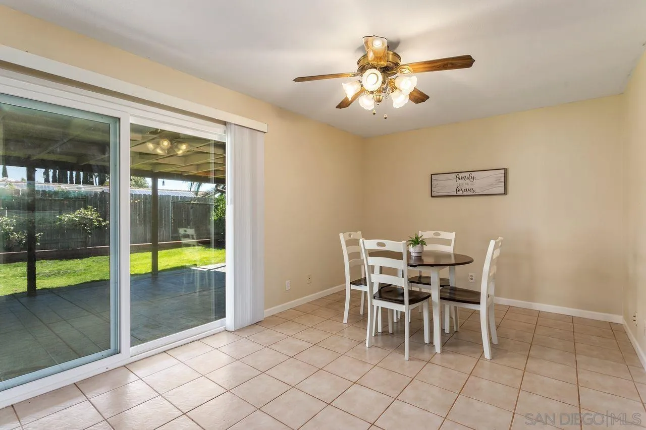 12805 Pinefield Road Poway, CA 92064 - Photo 13 of 31 a dining room with furniture and a floor to ceiling window