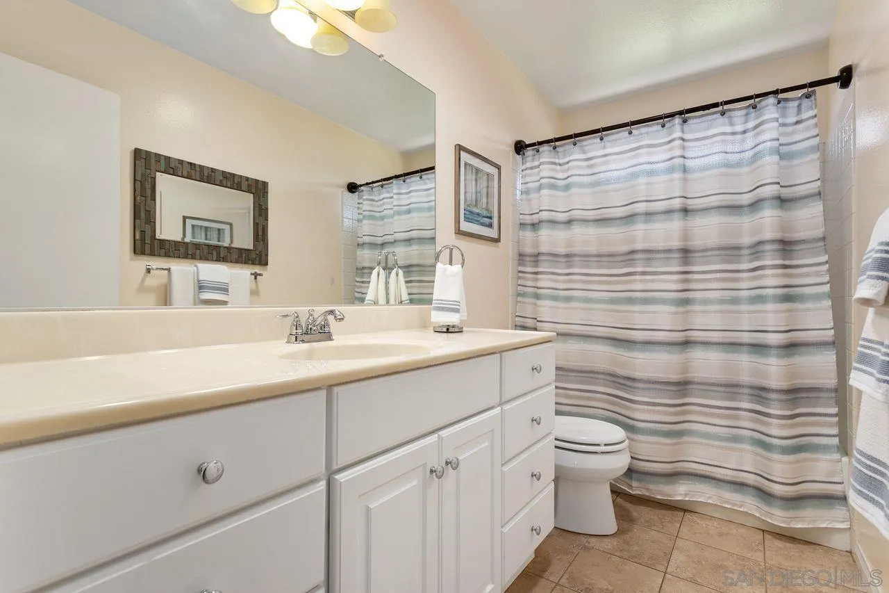 12805 Pinefield Road Poway, CA 92064 - Photo 15 of 31 a bathroom with a double vanity sink toilet and shower