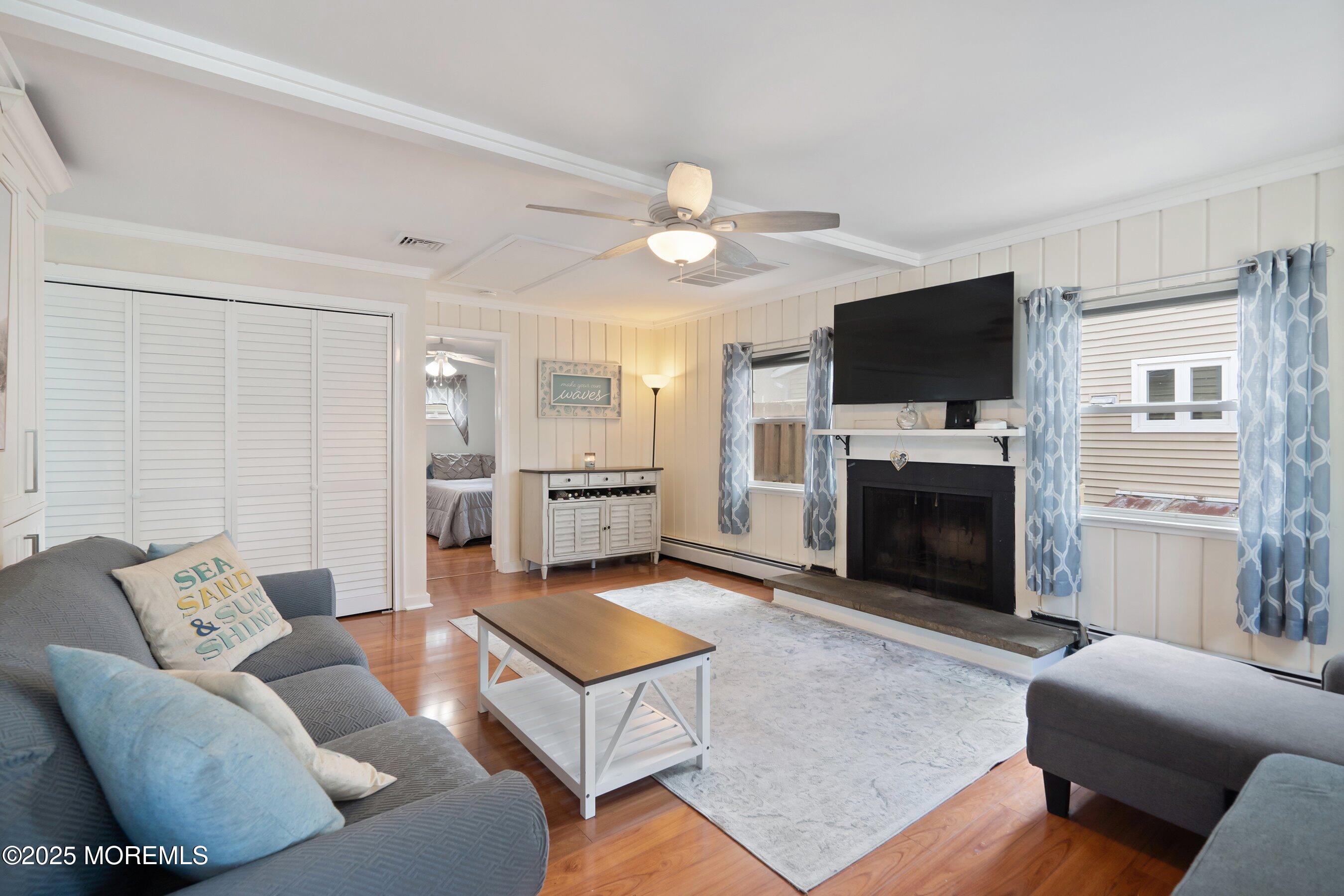 54 Buckingham Road Brick, NJ 08723 - Photo 6 of 35 a living room with furniture a flat screen tv and a fireplace