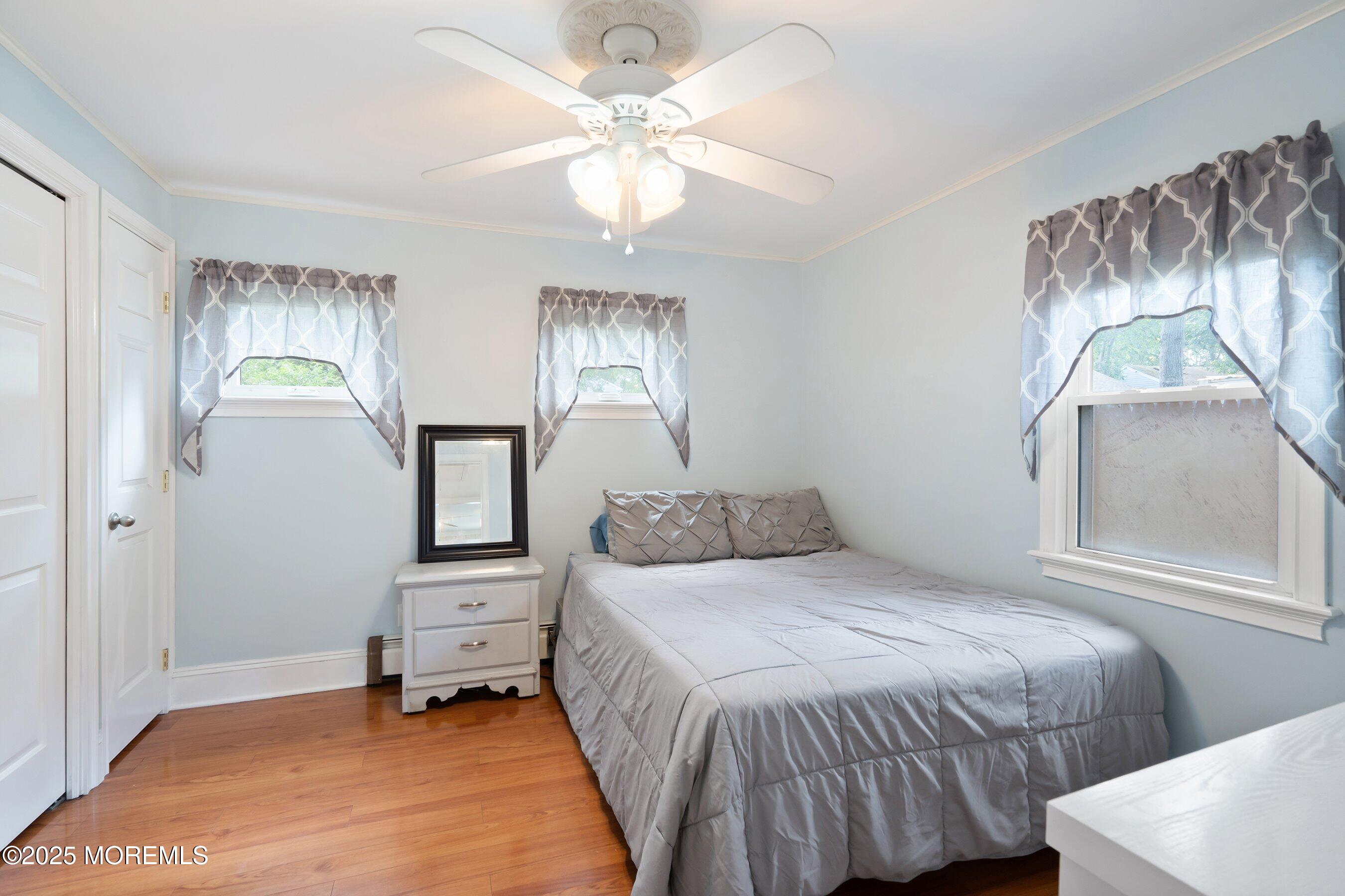 54 Buckingham Road Brick, NJ 08723 - Photo 8 of 35 a bedroom with a bed and a chandelier