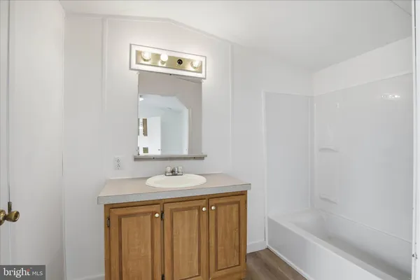 a bathroom with a sink a mirror and a bathtub