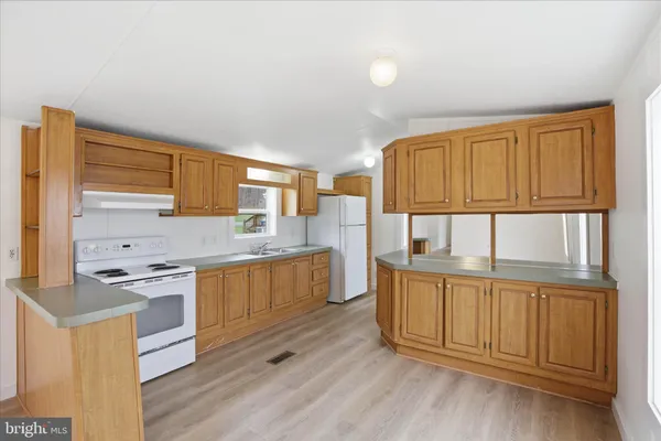 a kitchen with stainless steel appliances granite countertop a stove and a refrigerator