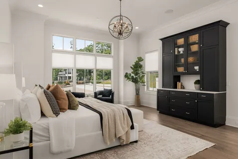 a bedroom with a large bed and a large window