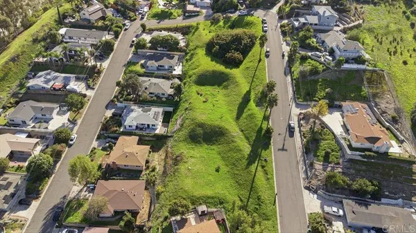an aerial view of a residential houses with outdoor space