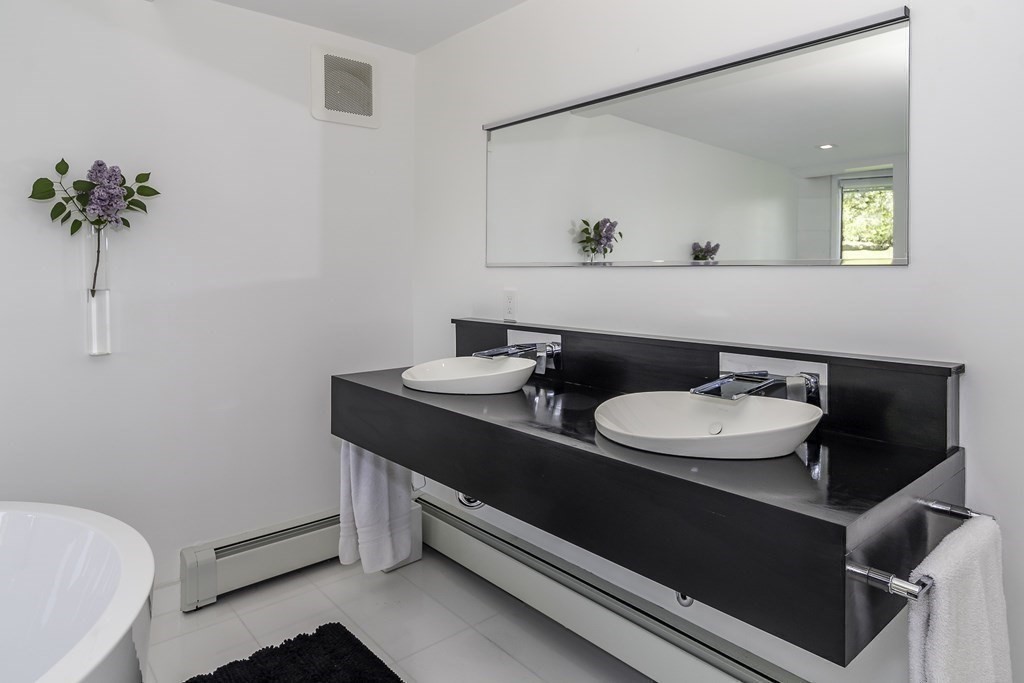 175 Oakland Street Wellesley, MA 02481 - Photo 20 of 28 a bathroom with a sink and a mirror