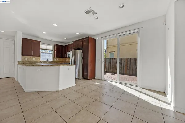 a view of kitchen with refrigerator and microwave