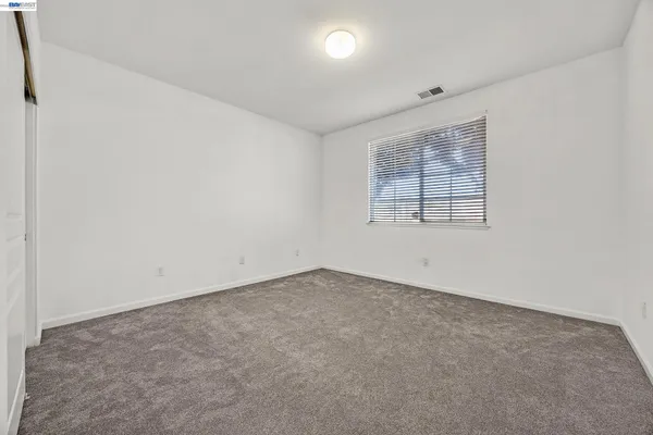 an empty room with mirror in it
