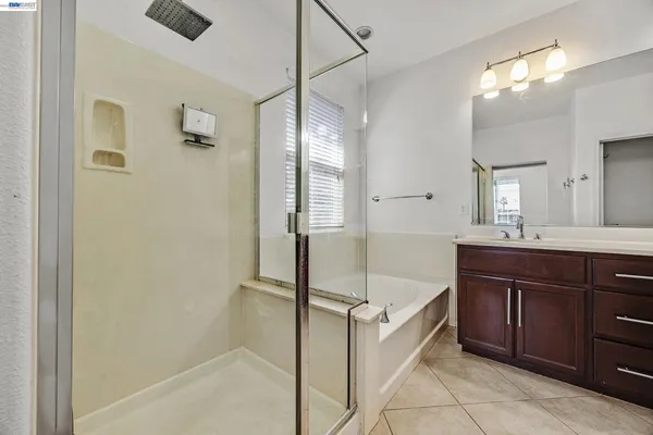 a bathroom with a double vanity sink and a mirror