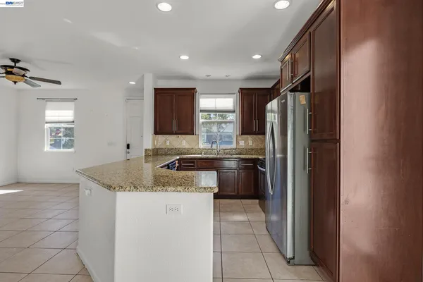 a kitchen with a sink refrigerator and microwave