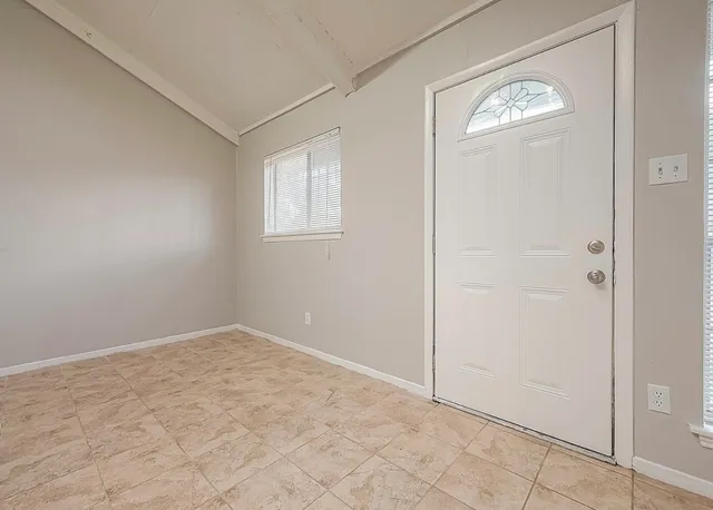 an empty room with windows and closet