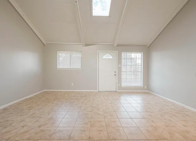 an empty room with windows and closet