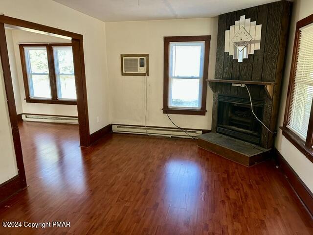 349 Shine Hill Road Henryville, PA 18332 - Photo 7 of 25 an empty room with wooden floor mirror and windows