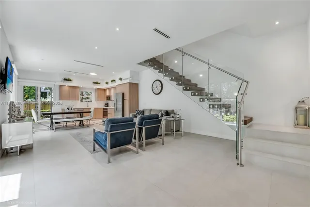 a living room with furniture and a clock