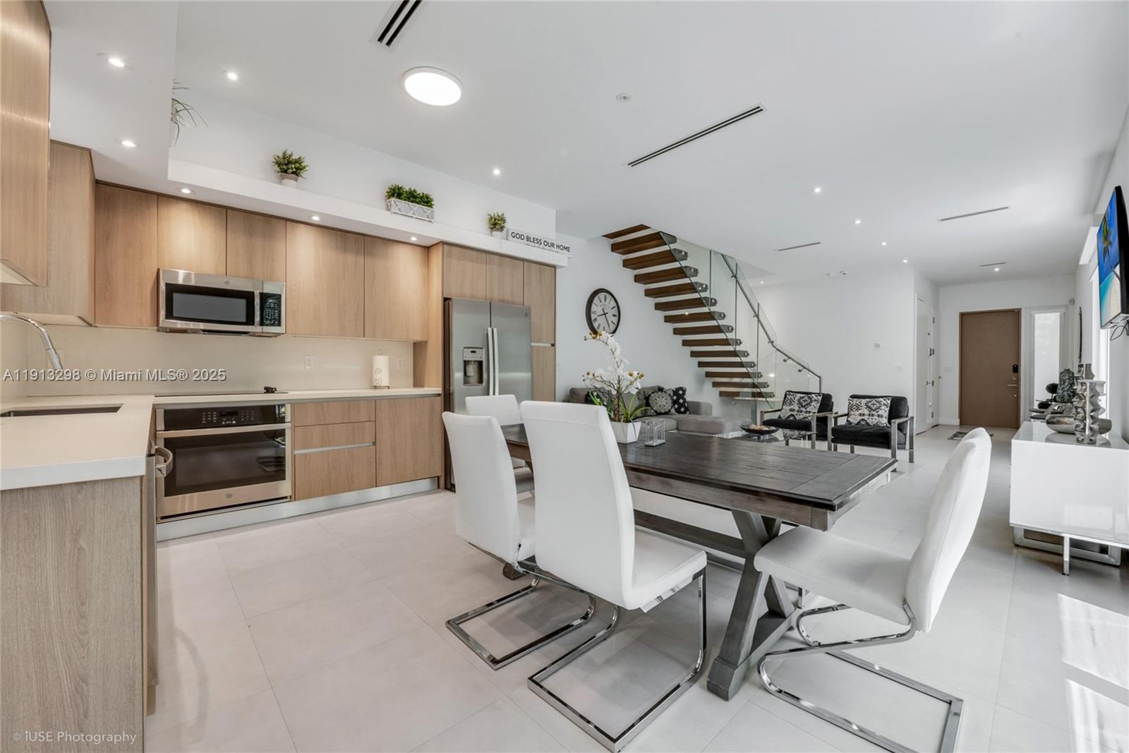 2868 Southwest 33rd Court, Unit 2868 Miami, FL 33133 - Photo 4 of 15 a view of kitchen with stainless steel appliances kitchen island granite countertop a stove a sink a dining table and chairs