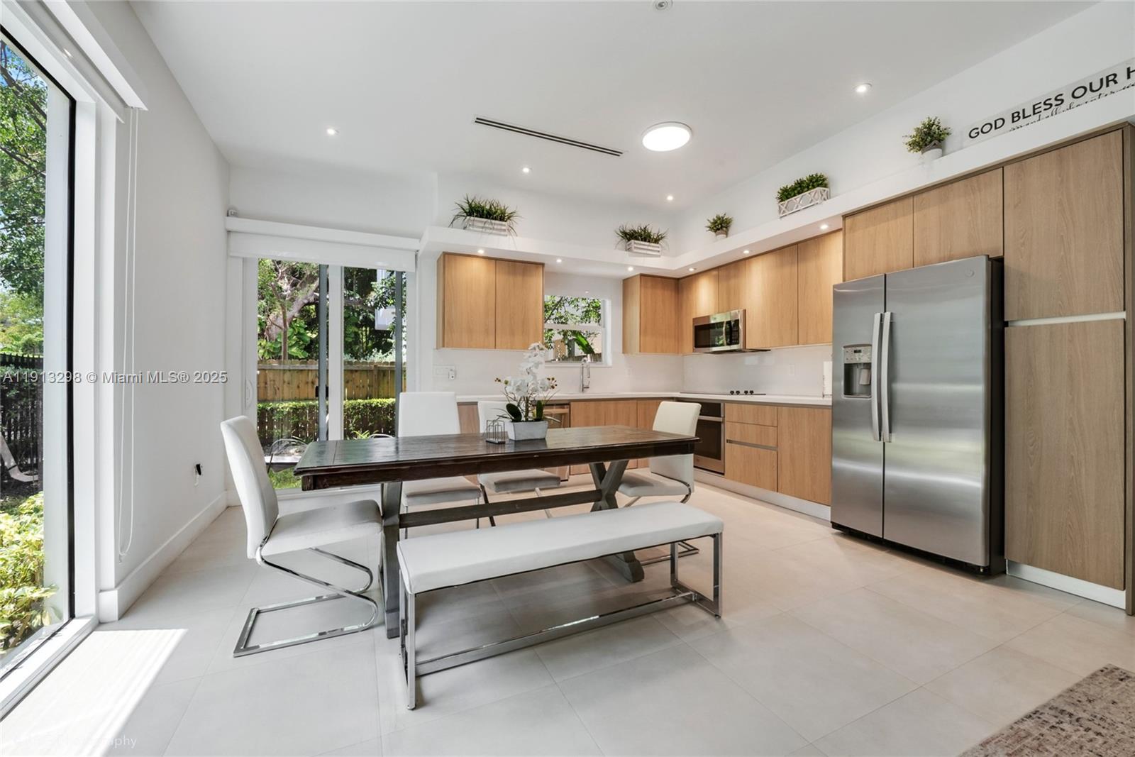 2868 Southwest 33rd Court, Unit 2868 Miami, FL 33133 - Photo 5 of 15 a living room with furniture a large window and stainless steel appliances