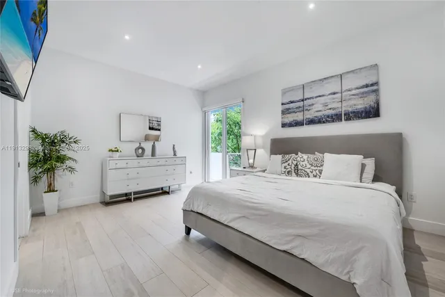 a bedroom with a bed and a potted plant