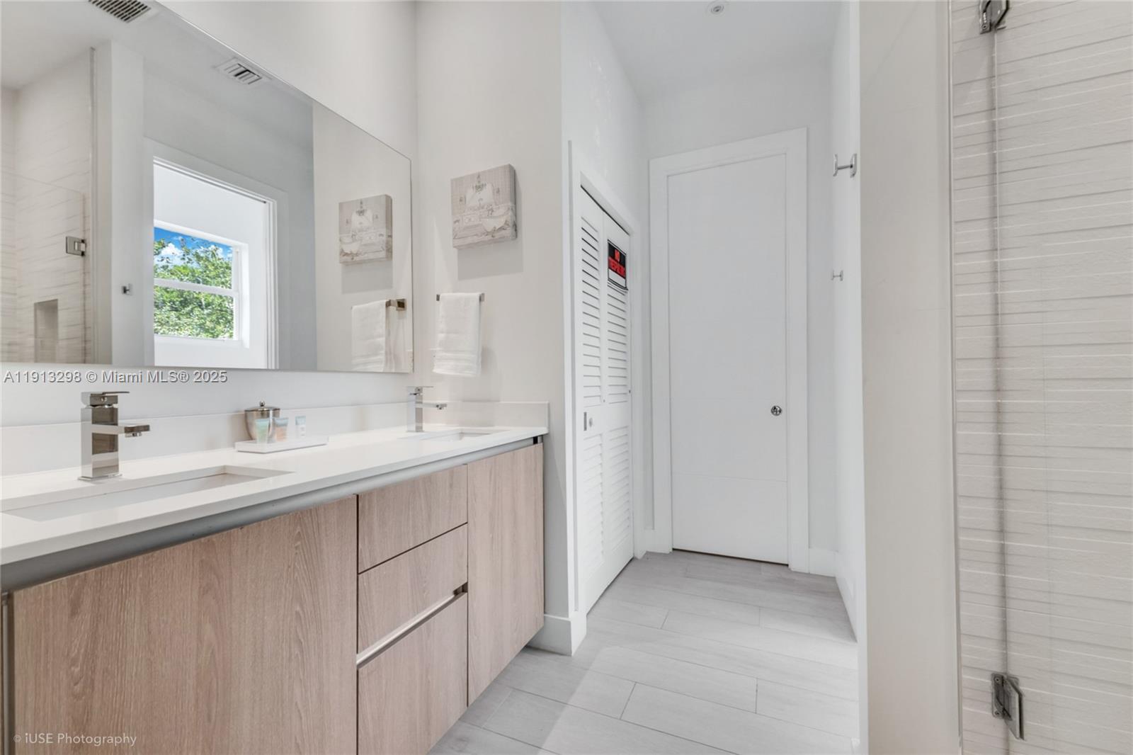 2868 Southwest 33rd Court, Unit 2868 Miami, FL 33133 - Photo 7 of 15 a bathroom with a double vanity sink and a mirror