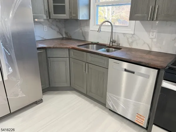 a kitchen with a sink cabinets and window