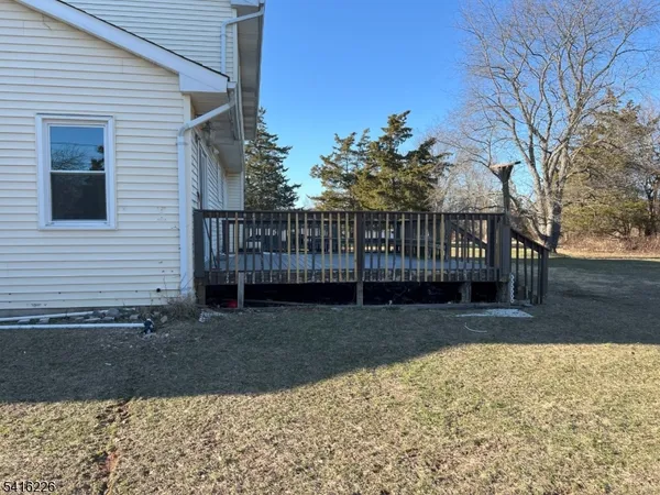 a view of a yard with wooden fence